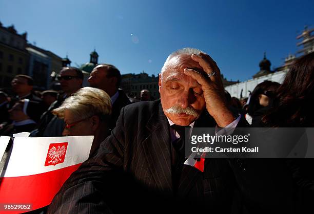 Man prays as he waits for the religious and military procession wich transports the coffin of late Polish President Lech Kazcynski from the St Mary's...