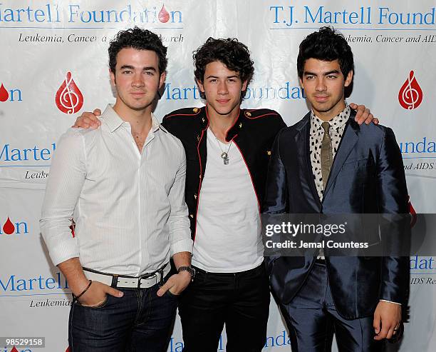 Singers Kevin Jonas, Nick Jonas and Joe Jonas of the group, The Jonas Brothers pose for a photo backstage at the 11th Annual T.J. Martell Foundation...