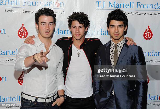 Singers Kevin Jonas, Nick Jonas and Joe Jonas of the group, The Jonas Brothers pose for a photo backstage at the 11th Annual T.J. Martell Foundation...