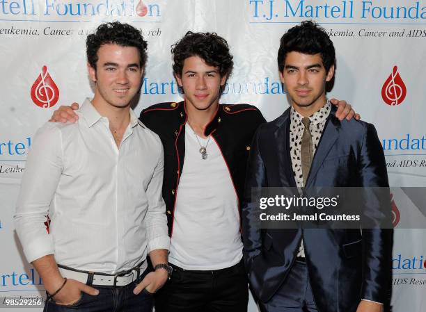 Singers Kevin Jonas, Nick Jonas and Joe Jonas of the group, The Jonas Brothers pose for a photo backstage at the 11th Annual T.J. Martell Foundation...
