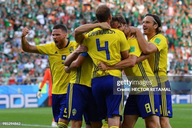 Sweden's defender Andreas Granqvist celebrates with teammates after scoring a penalty during the Russia 2018 World Cup Group F football match between...