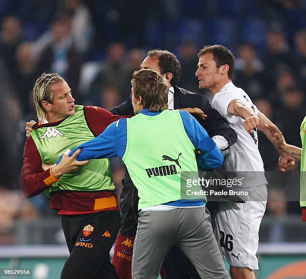 Philippe Mexes of AS Roma and Roberto Baronio and Stephan Radu of SS Lazio exchnage words the Serie A match between SS Lazio and AS Roma at Stadio...