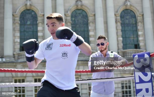 Belfast boxer Ryan Burnett watches Michael Conlan as he takes part in an open media workout at Belfast City Hall on June 27, 2018 in Belfast,...