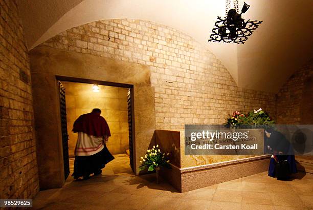 Priest and a nun stand at the sarcophagus of late Polish President Lech Kazcynski and his wife Maria following their official, state funeral at Wawel...