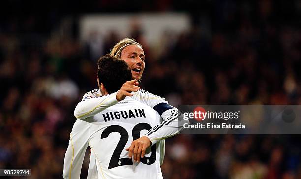 Gonzalo Higuain of Real Madrid celebrates with Guti after scoring during the La Liga match between Real Madrid and Valencia at Estadio Santiago...