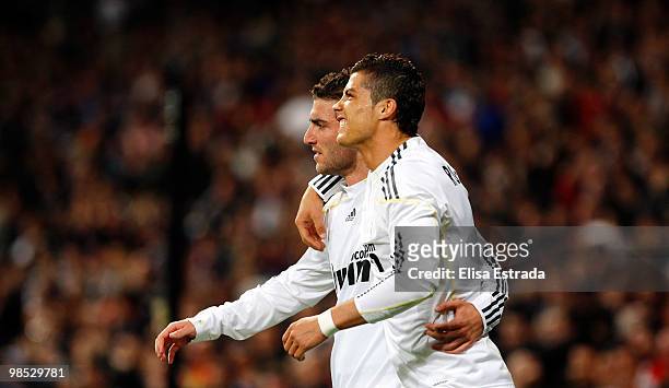 Gonzalo Higuain of Real Madrid celebrates with Cristiano Ronaldo after scoring during the La Liga match between Real Madrid and Valencia at Estadio...