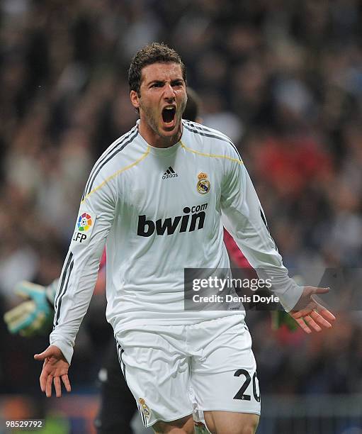 Gonzalo Higuain of Real Madrid celebrates scoring Real's first goal during the La Liga match between Real Madrid and Valencia at Estadio Santiago...