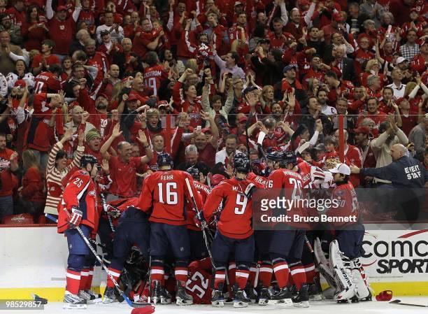 Nicklas Backstrom of the Washington Capitals scores his third goal of the game in overtime and is joined teammates as they defeat the Montreal...