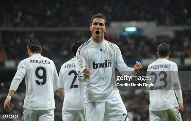 Gonzalo Higuain of Real Madrid celebrates scoring Real's first goal during the La Liga match between Real Madrid and Valencia at Estadio Santiago...
