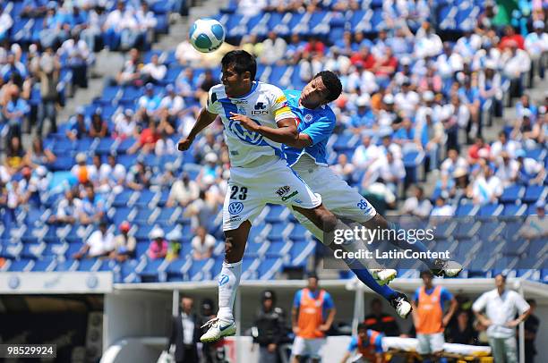 Joaquin Velazquez of Puebla fights for the ball with Edcarlos Conceicao of Cruz Azul during a match as part of the 2010 Bicentenary Tournament at the...