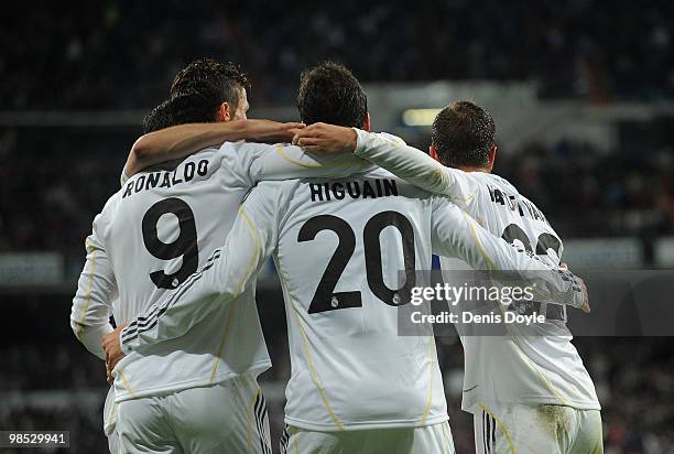 Gonzalo Higuain of Real Madrid celebrates with Cristiano Ronaldo (L and Rafael Van Der Vaart scoring Real's first goal during the La Liga match...