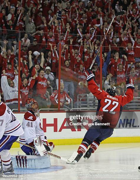 Nicklas Backstrom of the Washington Capitals scores his third goal of the game in overtime as Mike Knuble celebrates in front of Jaroslav Halak of...