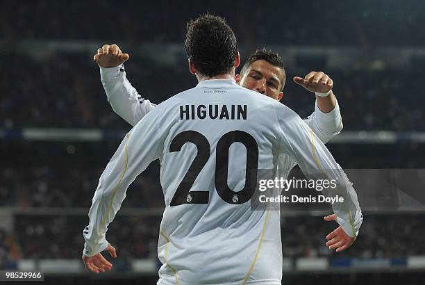 Gonzalo Higuain of Real Madrid celebrates with Cristiano Ronaldo after scoring Real's first goal during the La Liga match between Real Madrid and...