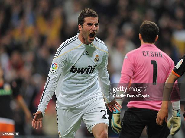 Gonzalo Higuain of Real Madrid celebrates scoring Real's first goal during the La Liga match between Real Madrid and Valencia at Estadio Santiago...