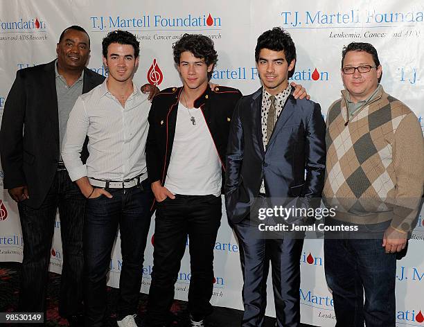 Johnny Wright, singers Kevin Jonas, Nick Jonas and Joe Jonas of the group, The Jonas Brothers and Kevin Jonas Sr. Pose for a photo backstage at the...