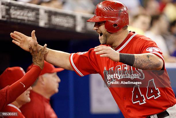 Mike Napoli of the Los Angeles Angels of Anaheim is congratulated after a run against the Toronto Blue Jays during a MLB game at the Rogers Centre...