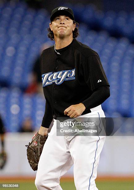 Scott Downs of the Toronto Blue Jays reacts to giving up a hit against the Los Angeles Angels of Anaheim during a MLB game at the Rogers Centre April...