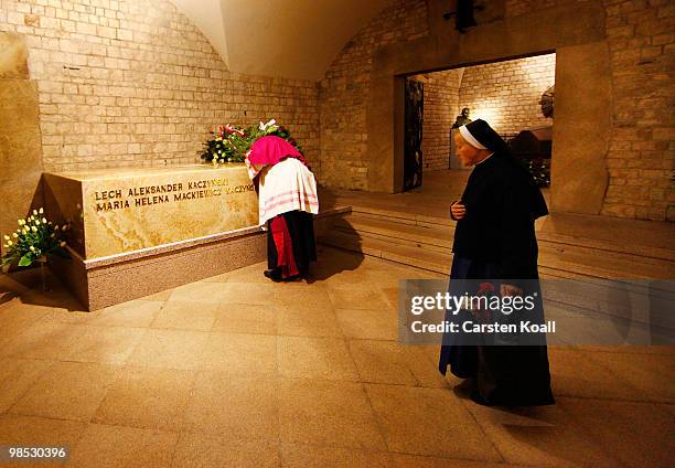 Priest and a nun stand at the sarcophagus of late Polish President Lech Kazcynski and his wife Maria following their official, state funeral at Wawel...