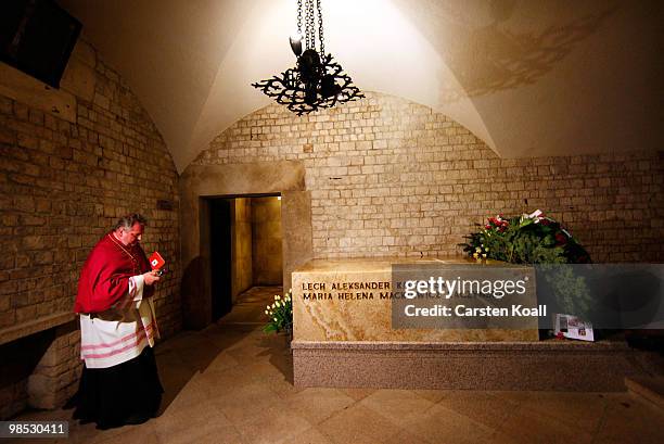 Priest stands at the sarcophagus of late Polish President Lech Kazcynski and his wife Maria following their official, state funeral at Wawel Castle...