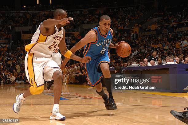 Thabo Sefolosha of the Oklahoma City Thunder dribbles against Kobe Bryant of the Los Angeles Lakers in Game One of the Western Conference...