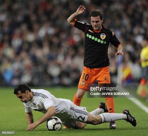 Real Madrid's defender Alvaro Arbeloa vies with Valencia's midfielder Juan Mata during the Spanish League football match Real Madrid against Valencia...