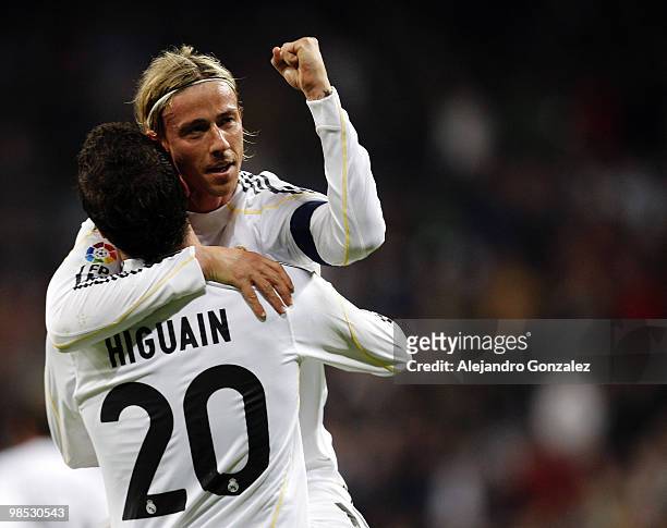 Gonzalo Higuain of Real Madrid celebrates with Guti after scoring during the La Liga match between Real Madrid and Valencia at Estadio Santiago...