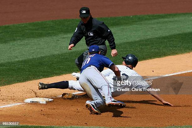 Alex Rodriguez of the New York Yankees avoids being tagged by Michael Young of the Texas Rangers on April 18, 2010 at Yankee Stadium in the Bronx...