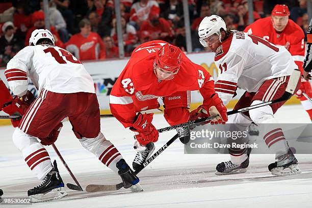 Darren Helm of the Detroit Red Wings gets tripped up by Petr Prucha of the Phoenix Coyotes and teammate Martin Hanzal during Game Three of the...