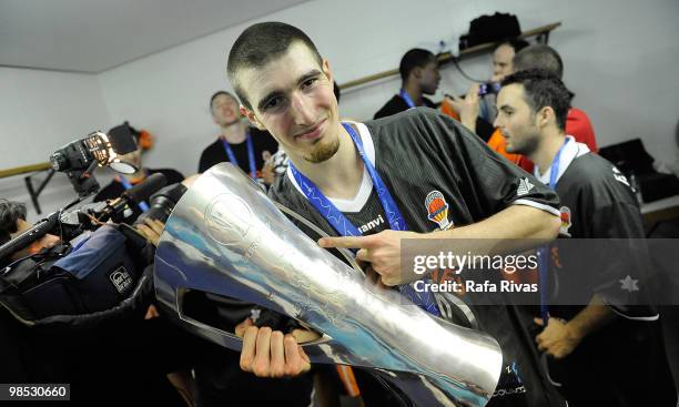 Nando De Colo, #22 of Power Electronics Valencia poses with the Eurocup trophy at locker rooms after the Champion Award Ceremony at Fernando Buesa...