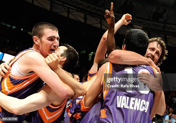 Nando De Colo and Matt Nielsen of Power Electronics Valencia celebrate their victory against Alba Berlin with teammates during the Champion Award...