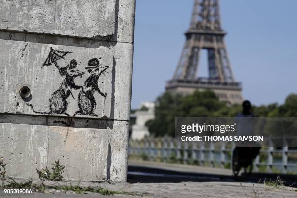 Recent artwork by street artist Banksy is pictured in Paris on June 27 near the Eiffel Tower . - Street artist Banksy has confirmed that he "blitzed"...
