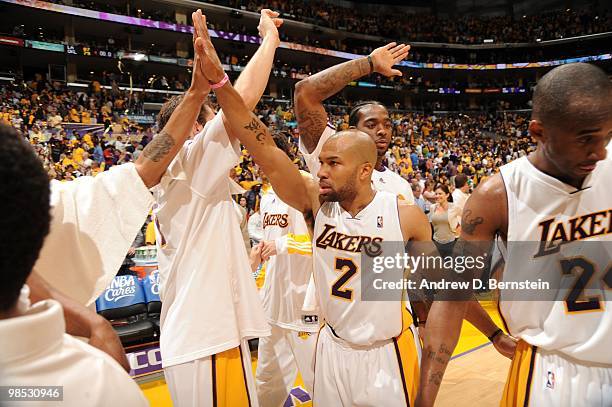 Derek Fisher, Luke Walton, Josh Powell, and Kobe Bryant of the Los Angeles Lakers come together following their team's victory over the Oklahoma City...