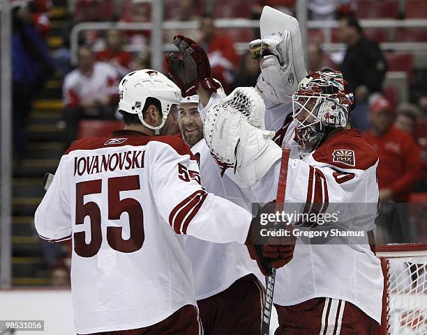 Ilya Bryzgalov of the Phoenix Coyotes is congratulated by Daniel Winnik and Ed Jovanovski after defeating the Detroit Red Wings 4-2 in Game Three of...