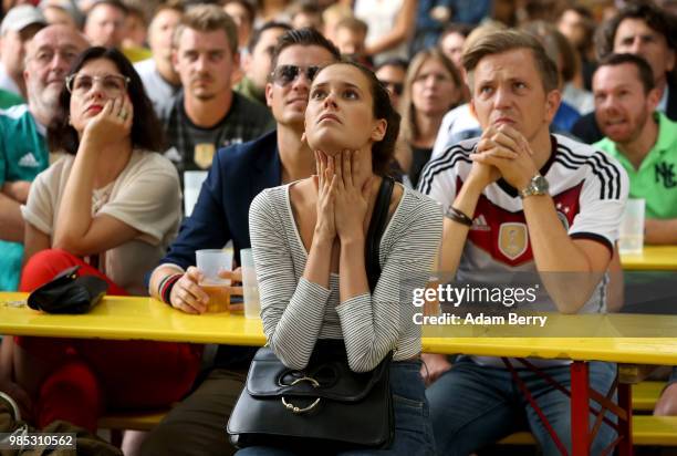 German team fans react as they watch Germany play South Korea in the teams' World Cup match, in a Biergarten on June 27, 2018 in Berlin, Germany....