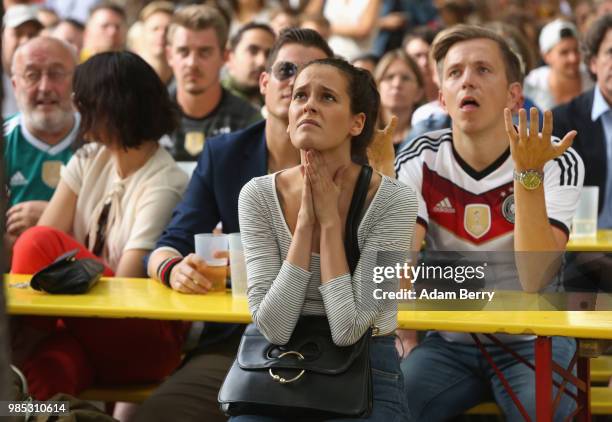 German team fans react as they watch Germany play South Korea in the teams' World Cup match, in a Biergarten on June 27, 2018 in Berlin, Germany....