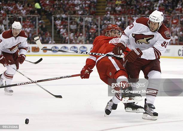 Adrian Aucoin of the Phoenix Coyotes checks takes down Valtteri Filppula the Detroit Red Wings during Game Three of the Western Conference...
