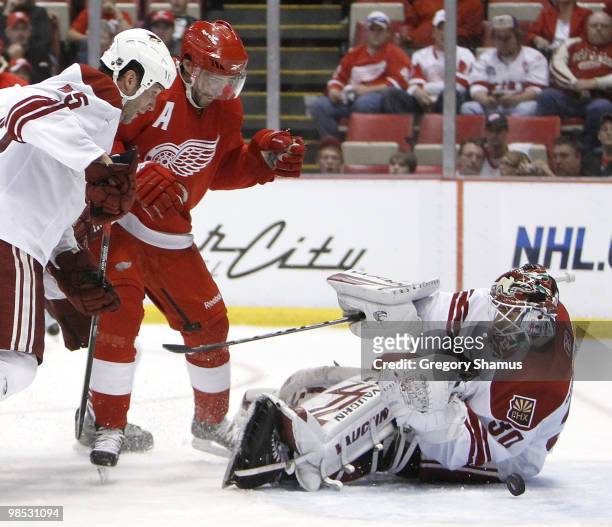 Ilya Bryzgalov of the Phoenix Coyotes stops a puck behind Pavel Datsyuk of the Detroit Red Wings and teammate Ed Jovanovski during Game Three of the...
