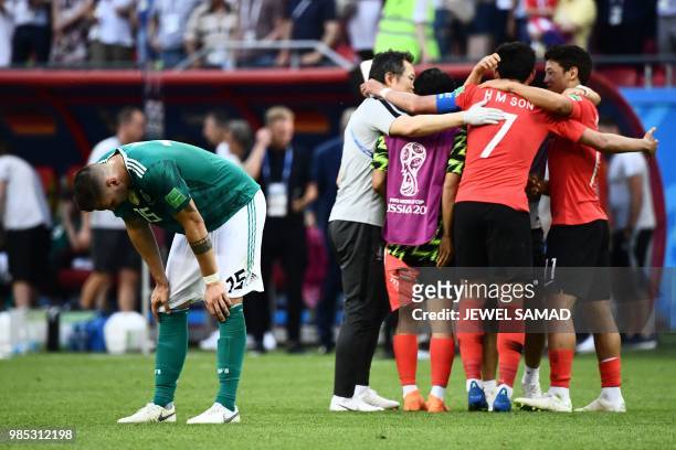 Germany's defender Niklas Suele reacts next to South Korea's team players celebrating at the end of the Russia 2018 World Cup Group F football match...