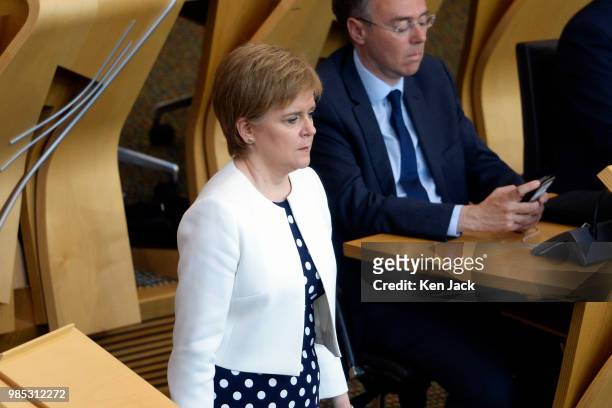 Scotland's First Minister Nicola Sturgeon makes her way to her seat during a debate in the Scottish Parliament after completing a reshuffle of...