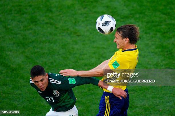 Sweden's midfielder Albin Ekdal heads the ball past Mexico's defender Edson Alvarez during the Russia 2018 World Cup Group F football match between...