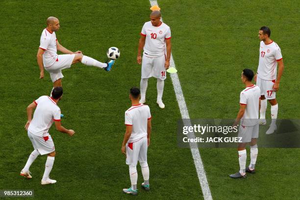 Tunisia's defender Yohan Benalouane controls the ball past teammates during a training session at the Mordovia Arena in Saransk on June 27 on the eve...