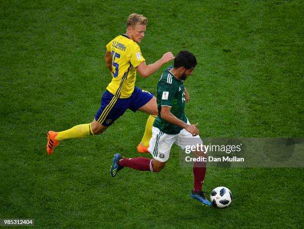 Carlos Vela of Mexico is challenged by Oscar Hiljemark of Sweden during the 2018 FIFA World Cup Russia group F match between Mexico and Sweden at...