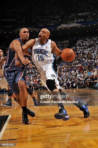 Vince Carter of the Orlando Magic drives against Boris Diaw of the Charlotte Bobcats in Game One of the Eastern Conference Quarterfinals during the...