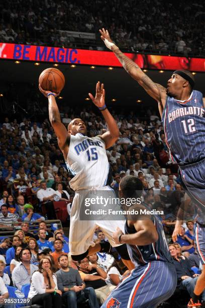 Vince Carter of the Orlando Magic shoots against Tyrus Thomas of the Charlotte Bobcats in Game One of the Eastern Conference Quarterfinals during the...