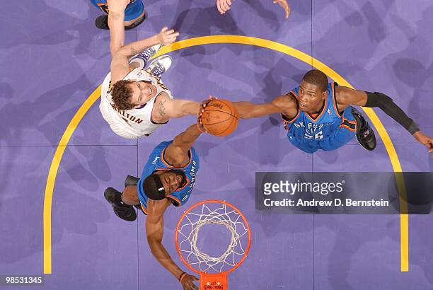 Luke Walton of the Los Angeles Lakers reaches for a rebound against James Harden and Kevin Durant of the Oklahoma City Thunder in Game One of the...