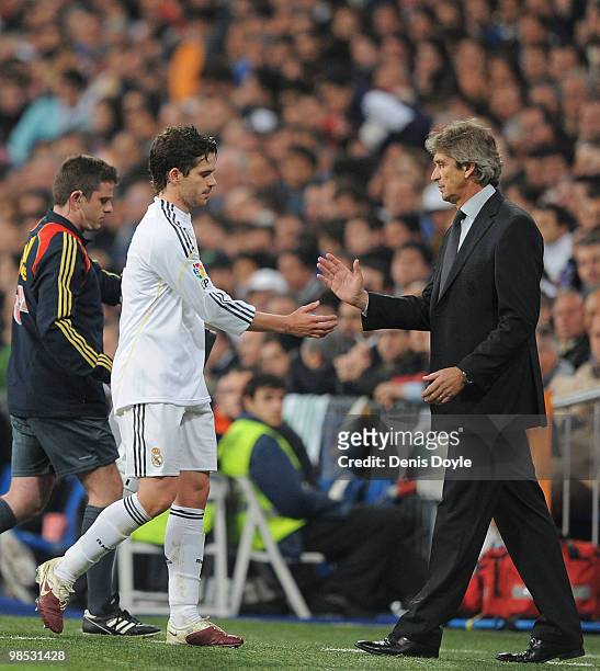 Fernando Gago of Real Madrid is congratulated by Real manager Manuel Pellegrini while being substituted during the La Liga match between Real Madrid...