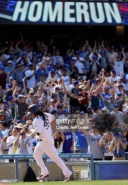 Fans celebrate as Manny Ramirez of the Los Angeles Dodgers rounds third base after hitting a two-run homerun in the eighth inning against the San...