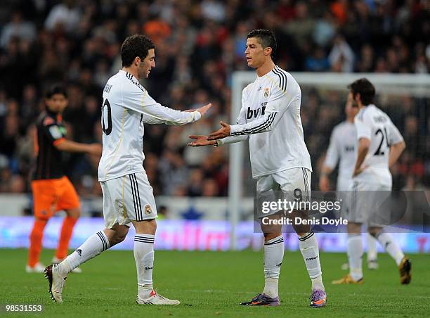 Gonzalo Higuain of Real Madrid is congratulated by Cristiano Ronaldo while being substituted during the La Liga match between Real Madrid and...