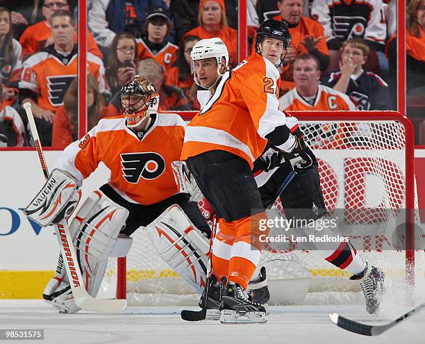 Dainius Zubrus of the New Jersey Devils is tied up by Chris Pronger of the Philadelphia Flyers in front of Flyers goaltender Brian Boucher in Game...