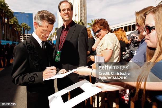 Singer Randy Travis signs autographs for fans at the 45th Annual Academy of Country Music Awards at the MGM Grand Garden Arena on April 18, 2010 in...